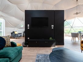 A living room with a television and seating area at The Dome in Great Ayton