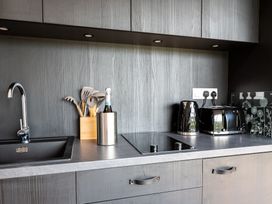A kitchen with a sink, utensils, and appliances at The Dome in Great Ayton