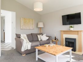 A living room with a sofa and television at Greystone in Great Ayton