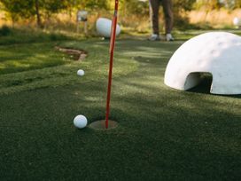 Golf hole with a golf ball on the putting green at Greystone in Great Ayton