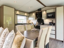 A kitchen with a dining table and cabinets at The Woods in Great Ayton