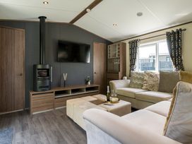 A living room with a sofa and a TV at The Woods in Great Ayton