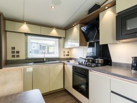 A kitchen with cooking appliances and sink at The Woods in Great Ayton