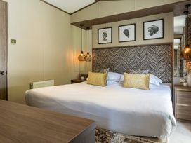 A bedroom with a bed and wall art at The Woods in Great Ayton