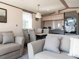 A living room with a sofa and dining area at The Woods in Great Ayton
