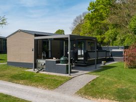 A house with a deck and grass at The Woods (Pet) Great Ayton