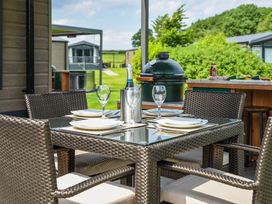 An outdoor dining area with a table and chairs at The Woods (Pet) Great Ayton