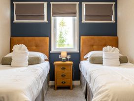 A bedroom with two beds and a nightstand at Rosedale in Great Ayton