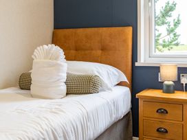 A bedroom with a bed and a nightstand at Rosedale in Great Ayton