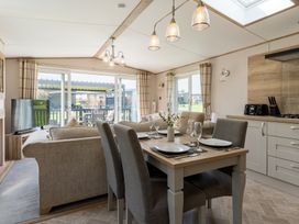 A living room with a dining area and kitchen at Leven (Pet) Great Ayton