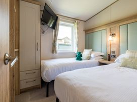 A bedroom with two beds and a television at Leven (Pet) in Great Ayton