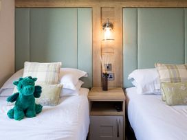 A bedroom with two beds and a plush toy at Leven (Pet) in Great Ayton