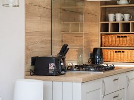 A kitchen with a toaster, kettle, and gas stove at Leven (Pet) Great Ayton