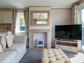 A living room with a sofa and television at Leven (Pet) in Great Ayton