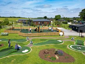 An outdoor play area with playground equipment and mini golf at Leven (Pet) Great Ayton