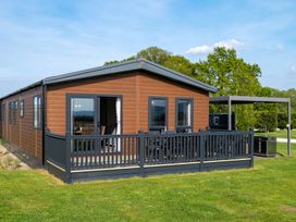 A cabin with decking and windows at Roseberry in Great Ayton