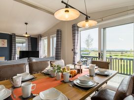 A dining room with a table set for meals at Roseberry in Great Ayton