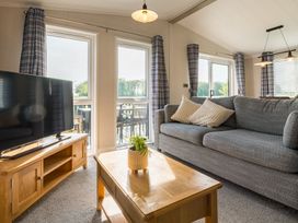 A living room with a television and coffee table at Roseberry in Great Ayton