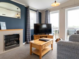 A living room with a television and fireplace at Roseberry Great Ayton