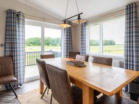 A dining room with a table and chairs at Roseberry (Pet) Great Ayton