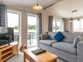 A living room with a television and sofa at Roseberry (Pet) in Great Ayton