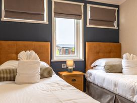 A bedroom with two beds and a window at Roseberry (Pet) in Great Ayton