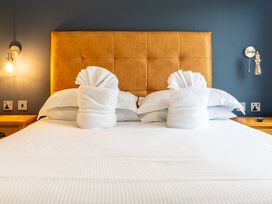 A bedroom with a bed and towel origami at Roseberry (Pet) Great Ayton