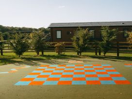 An outdoor area with a checkered pattern and a building at Roseberry (Pet) Great Ayton