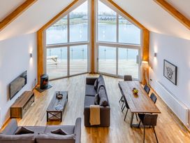 A living room with a sofa and dining table at Tranquillity 3 (Pet) Carnforth