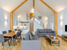 A living room with a sofa and dining table at Tranquillity 3 (Pet) in Carnforth