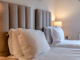 A bedroom with two beds and a lamp at Tranquillity 3 (Pet) Carnforth