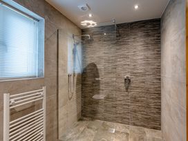 A bathroom with a shower enclosure and towel radiator at Tranquillity 3 (Pet) Carnforth