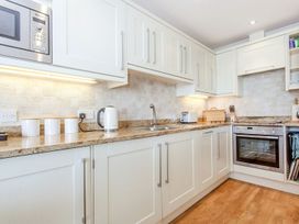 A kitchen with cabinets and appliances at 2 Burgh Island Causeway Kingsbridge