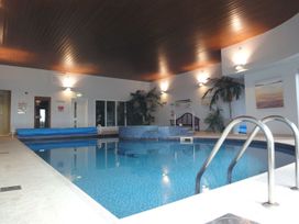 A swimming pool with seating area at 2 Burgh Island Causeway in Kingsbridge