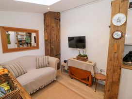 A living room with a sofa and television at Flat 4 in Evesham