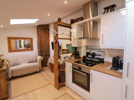 A kitchen with a sofa and mirror at Flat 4 in Evesham