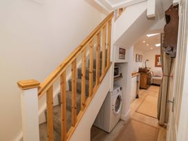A hallway with stairs and a washing machine at Flat 4 in Evesham