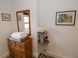 A bathroom with a mirror and chest of drawers at Flat 4 in Evesham