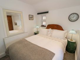 A bedroom with a bed and lamp at Flat 4 in Evesham