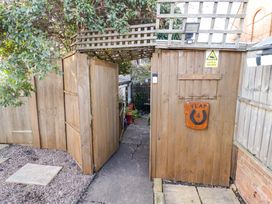 A gated entryway with a sign labeled Flat 4 at Flat 4 in Evesham