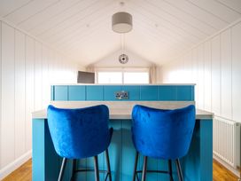 A kitchen with bar stools and a countertop at The Grays in North Berwick