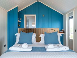 A bedroom with a bed and towels at The Grays in North Berwick