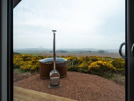 A hot tub with a chimney and landscape view at The Grays in North Berwick