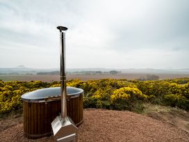A hot tub with a chimney on a landscape at The Grays in North Berwick