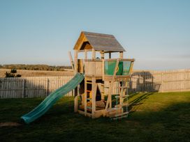 A playhouse with a slide in a yard at The Grays in North Berwick