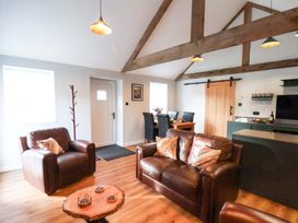 A living room with a sofa and dining area at The Homestead in Moorsholm