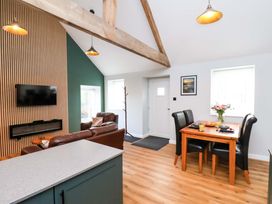 A living room with a sofa and dining table at The Homestead in Moorsholm