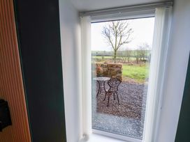 A view from a window showing a table and chair outside at The Homestead in Moorsholm