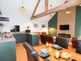 A kitchen with dining table and sofa at The Homestead in Moorsholm