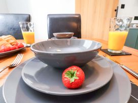 A dining table set with plates and a bowl at The Homestead in Moorsholm